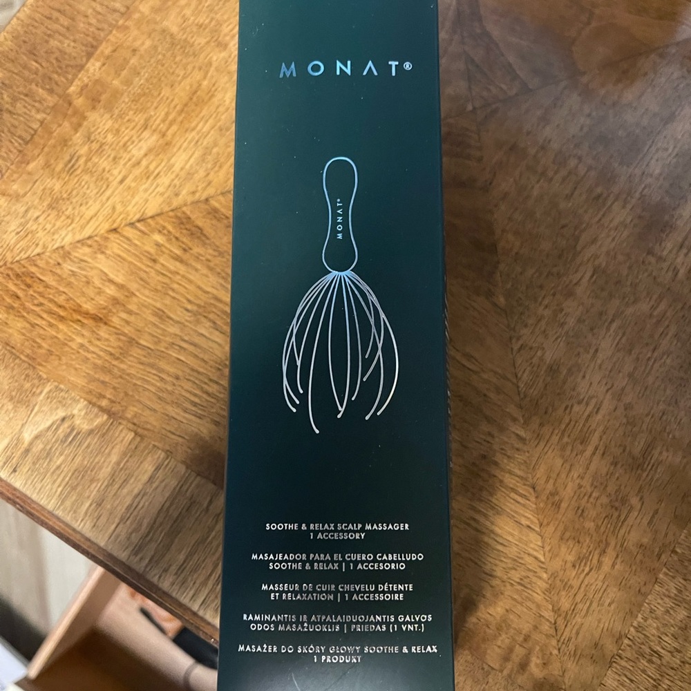 MONAT branded hair brush and head massager